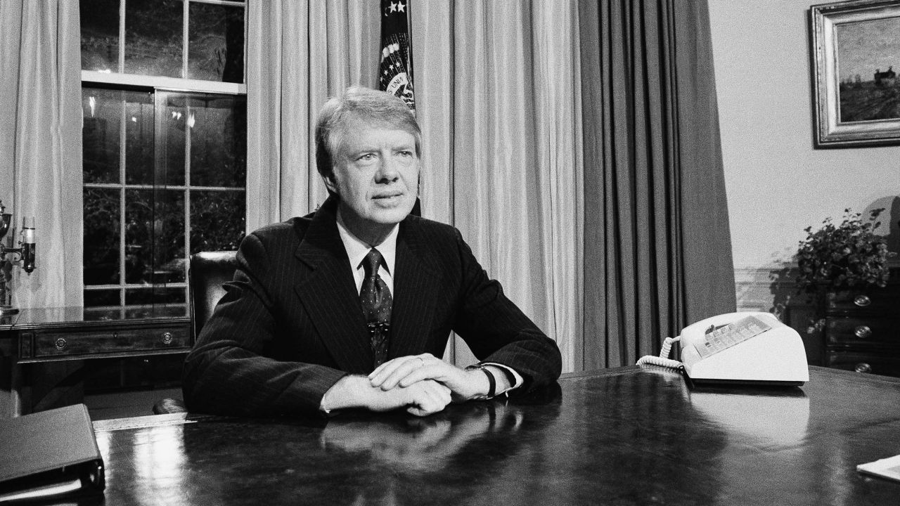 Pres. Jimmy Carter is seated at his desk in the Oval Office prior to delivering his message on energy, Monday, April 19, 1977, Washington, D.C. The President made his statements on nationwide television and radio saying that many of his proposals on energy will be unpopular. (AP Photo/Charles W. Harrity)