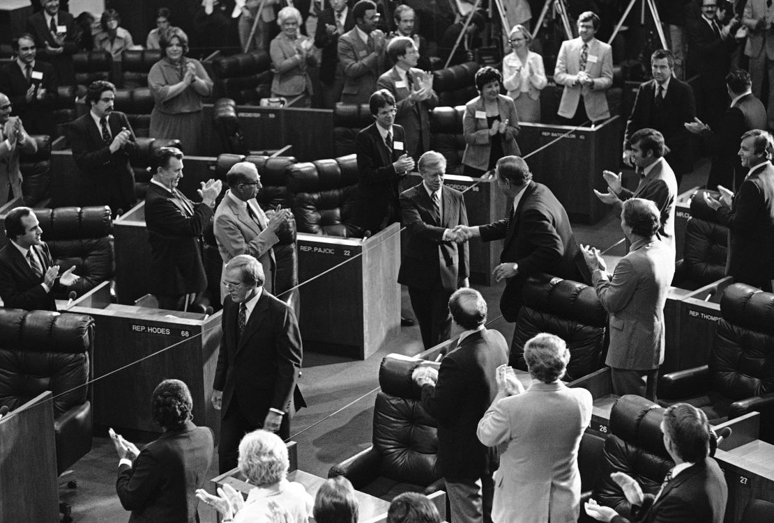 Florida Democrats shake President Jimmy Carter's hand as he enters the Florida House of Representatives chamber on October 10, 1980, prior to signing a bill providing up to $100 million to help reimburse Florida and other states after an influx of arrivals from Cuba and Haiti.