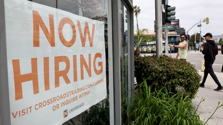 A 'Now Hiring' sign is displayed outside a resale clothing shop on June 2, 2023 in Los Angeles, California. Today's U.S. labor report shows that employers added 339,000 jobs in May with sectors including construction, healthcare, business services and transportation adding jobs with wages showing 4.3 percent growth over the same period last year. 