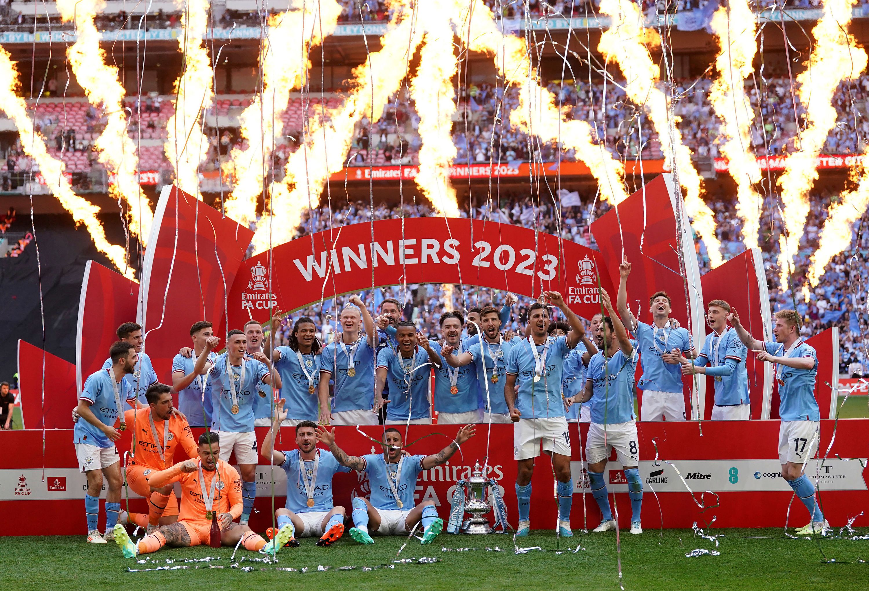 Manchester City's Erling Haaland holds the winners trophy as he celebrates  winning the English FA Cup final soccer match between Manchester City and  Manchester United at Wembley Stadium in London, Saturday, June