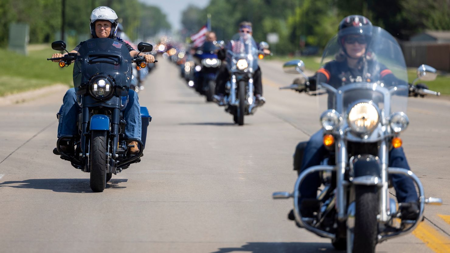 Former Vice President Mike Pence, left, and Iowa Sen. Joni Ernst, right, ride motorcycles during the annual "Roast and Ride" gathering in Des Moines on June 3, 2023. 
