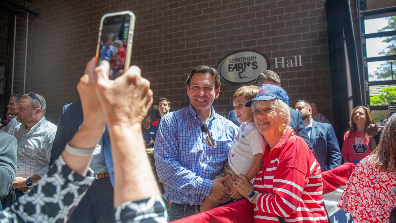 Florida Governor Ron DeSantis poses for a photo with attendees of the Roast and Ride in Des Moines on June 3, 2023. 