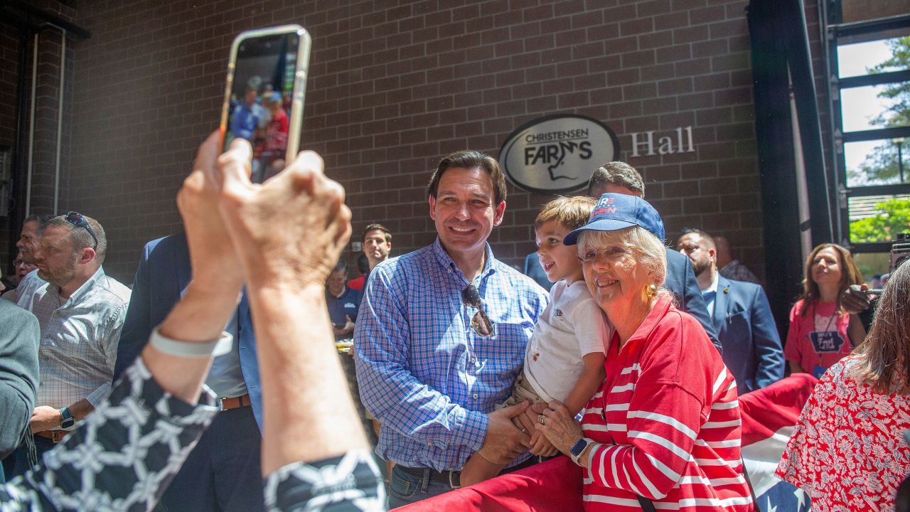Florida Governor Ron DeSantis poses for a photo with attendees of the Roast and Ride in Des Moines on June 3, 2023.