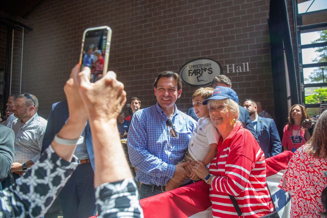 Florida Gov. Ron DeSantis takes a photograph with Roast and Ride attendees in Des Moines on June 3, 2023. 