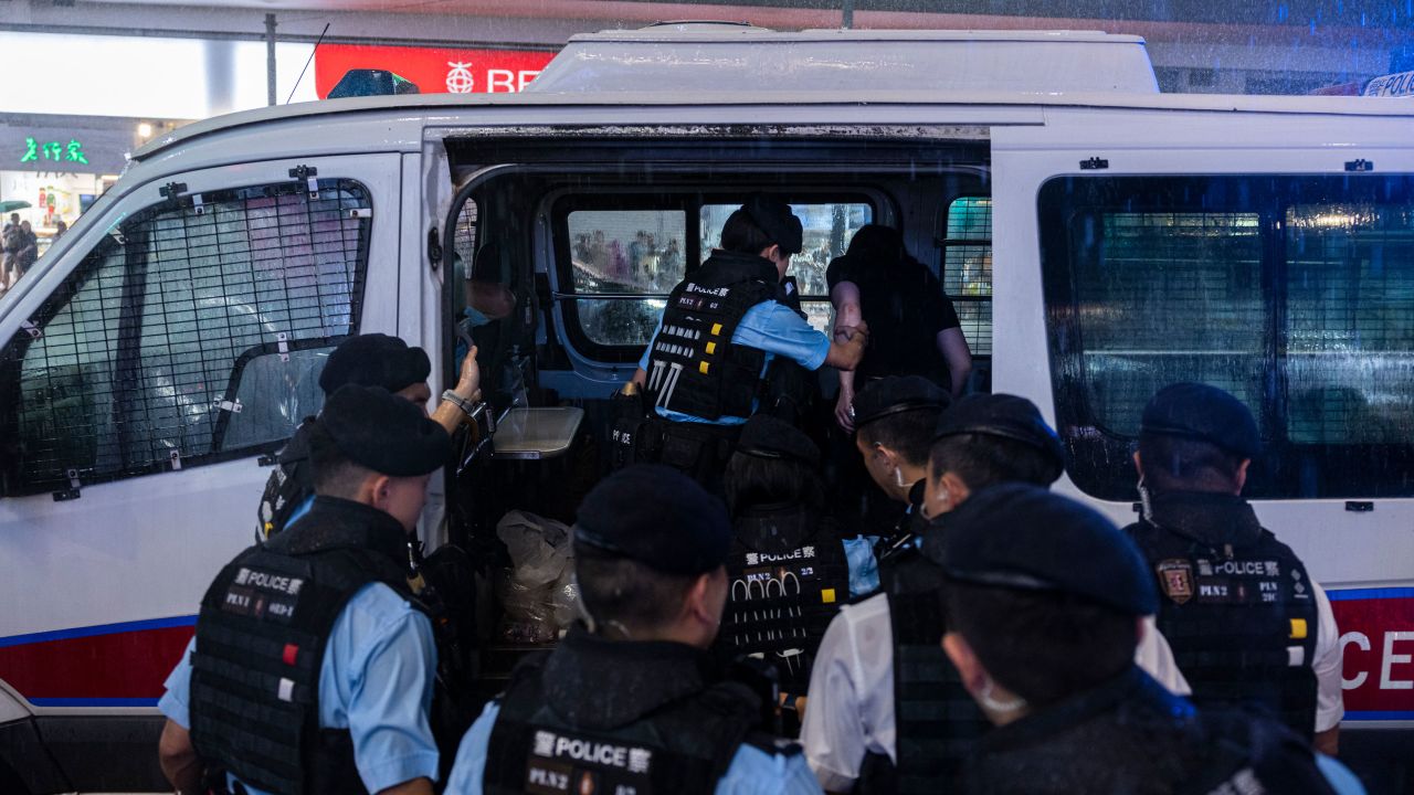 Police officers take away a member of the public into a police van in the Causeway Bay area on the eve 34th anniversary of China's Tiananmen Square massacre in Hong Kong.