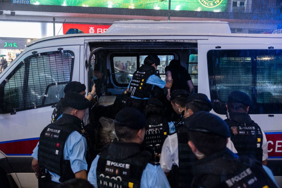 Police officers take away a member of the public into a police van in the Causeway Bay area on the eve 34th anniversary of China's Tiananmen Square massacre in Hong Kong.