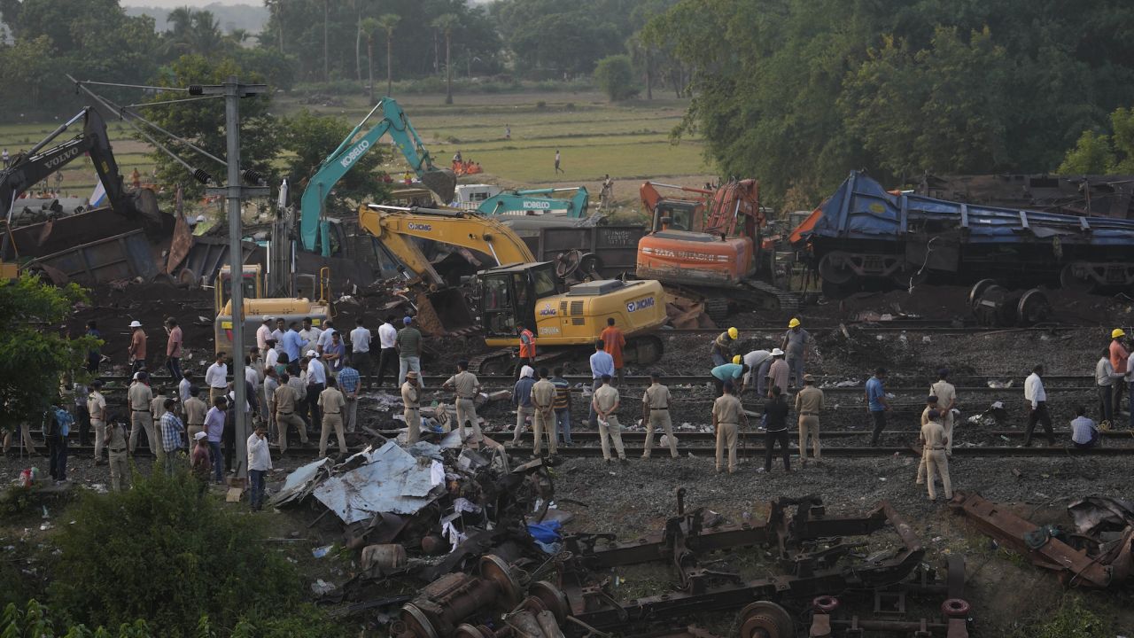 Policemen stand guard at the site of the crash in Balasore on Sunday.