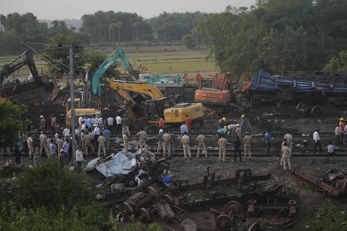 Policemen stand guard at the site where trains that derailed, in Balasore district, in the eastern Indian state of Odisha, Sunday, June 4, 2023. 