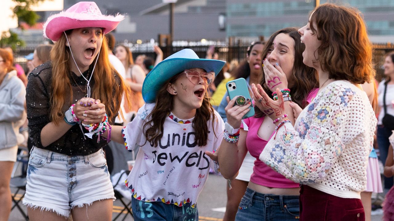(From left) Shayna Weachter, Cecelia Zschunke, Riley O'Brien, and Rayana Weachter scream when Taylor Swift's set begins, which they are listening to from the parking lot outside of Lincoln Financial Field, in Philadelphia, Pennsylvania in May.