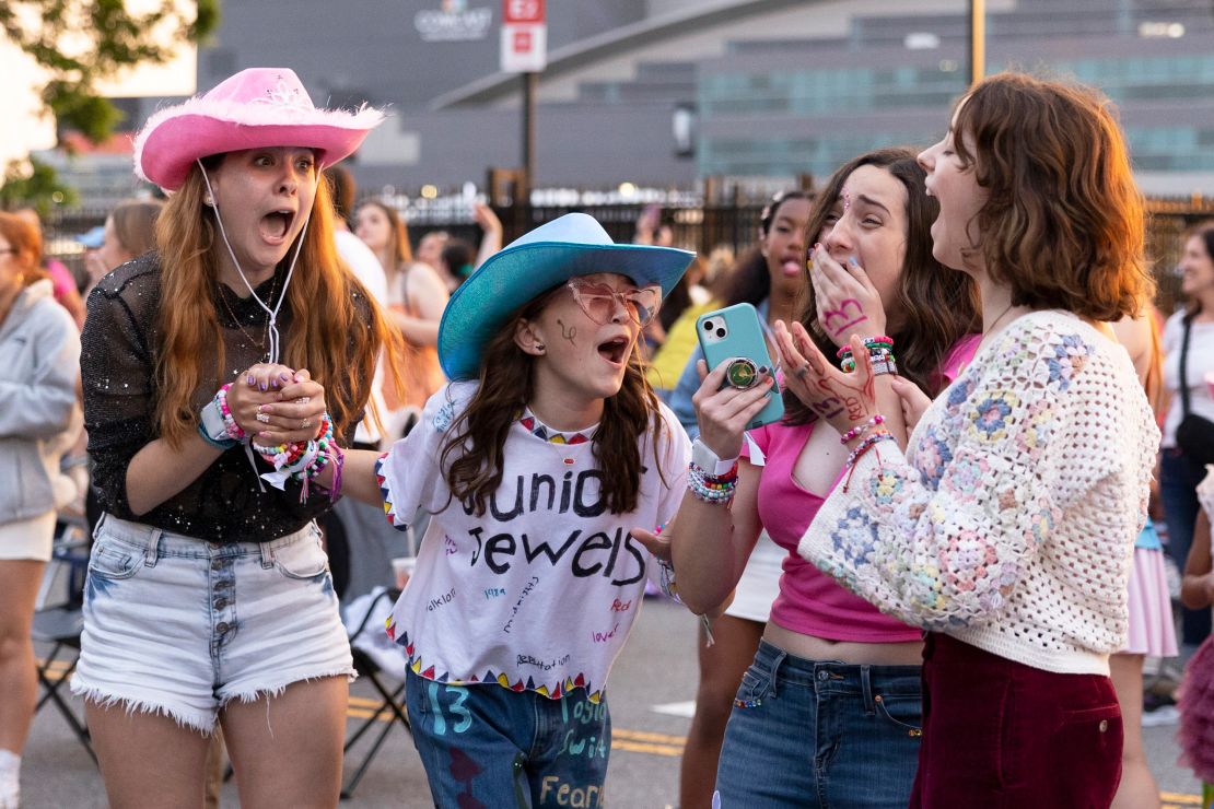 (From left) Shayna Weachter, Cecelia Zschunke, Riley O'Brien, and Rayana Weachter scream when Taylor Swift's set begins, which they are listening to from the parking lot outside of Lincoln Financial Field, in Philadelphia, Pennsylvania in May.
