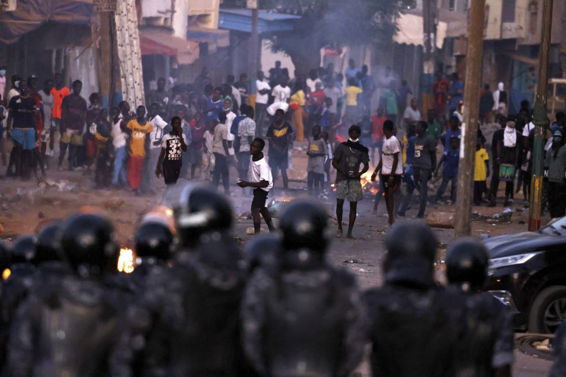 Security forces look at supporters of Senegal opposition leader Ousmane Sonko during clashes after Sonko was sentenced to prison, in Dakar, Senegal,  June 3, 2023.