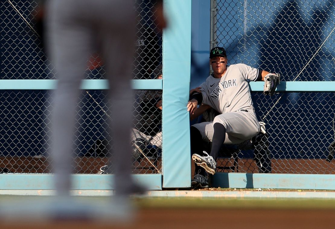 Judge crashes through the outfield fence as he makes a catch against the Dodgers. 