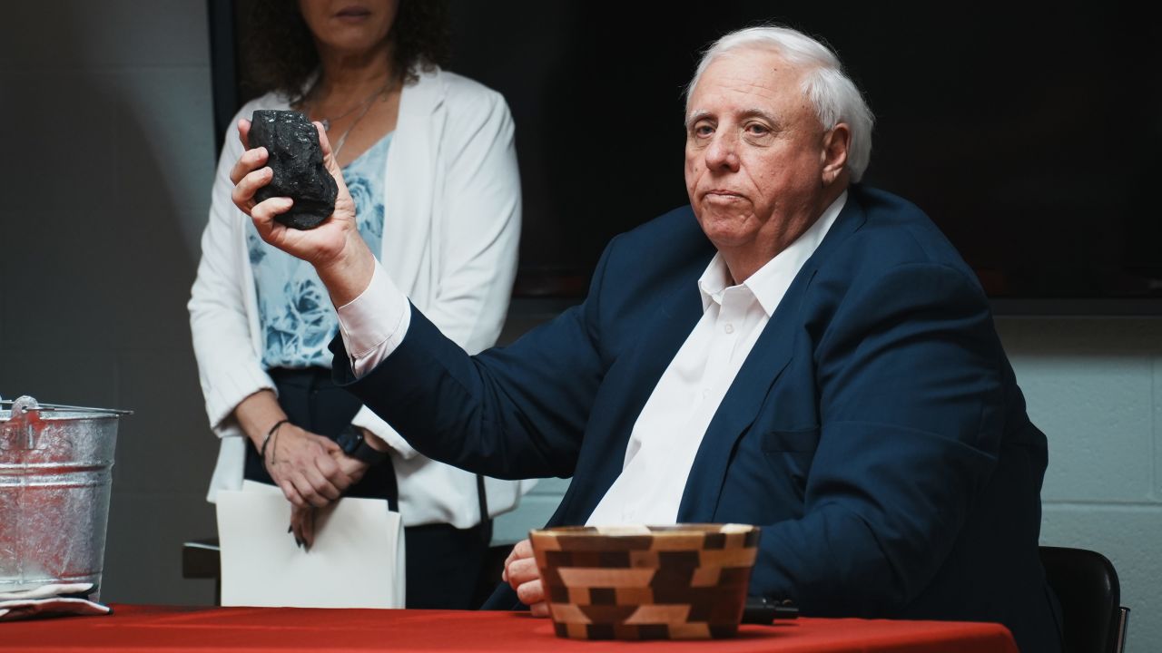 Gov. Jim Justice holds a lump of coal at a bill-signing ceremony for new coal-related legislation at John Amos Power Plant in Putnam County, West Virginia, in March.