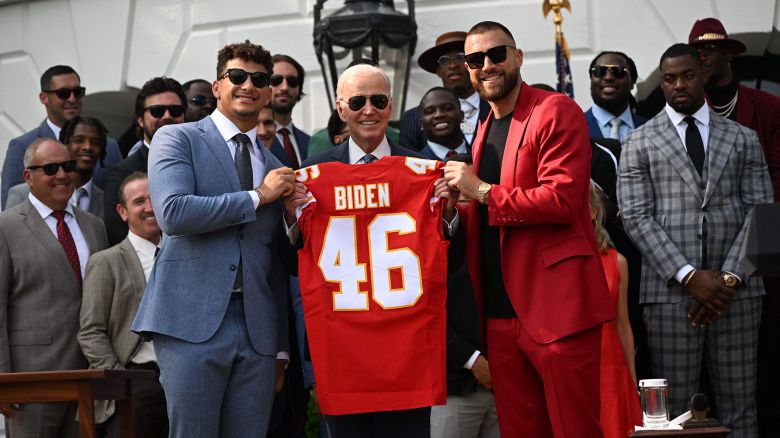 Kansas City Chiefs tight end Travis Kelce and quarterback Patrick Mahomes present US President Joe Biden with a jersey during a celebration for the Kansas City Chiefs, 2023 Super Bowl champions, on the South Lawn of the White House in Washington, DC, on June 5.