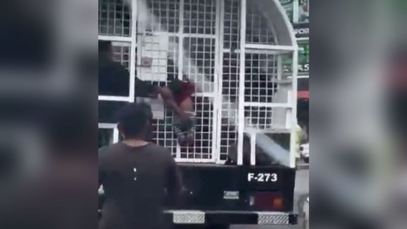 NextImg:Child hanging from government truck sparks outrage in the Dominican Republic | CNN