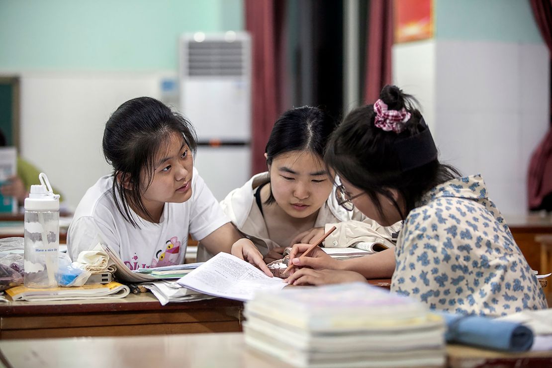 Three students study for the gaokao in a classroom on June 5 in Jiaozuo, China.