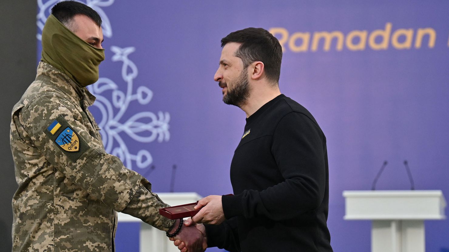 Ukrainian President Volodymyr Zelensky, right, presents Viktor Shevchenko with a medal for his military service to Ukraine on April 7, 2023. 