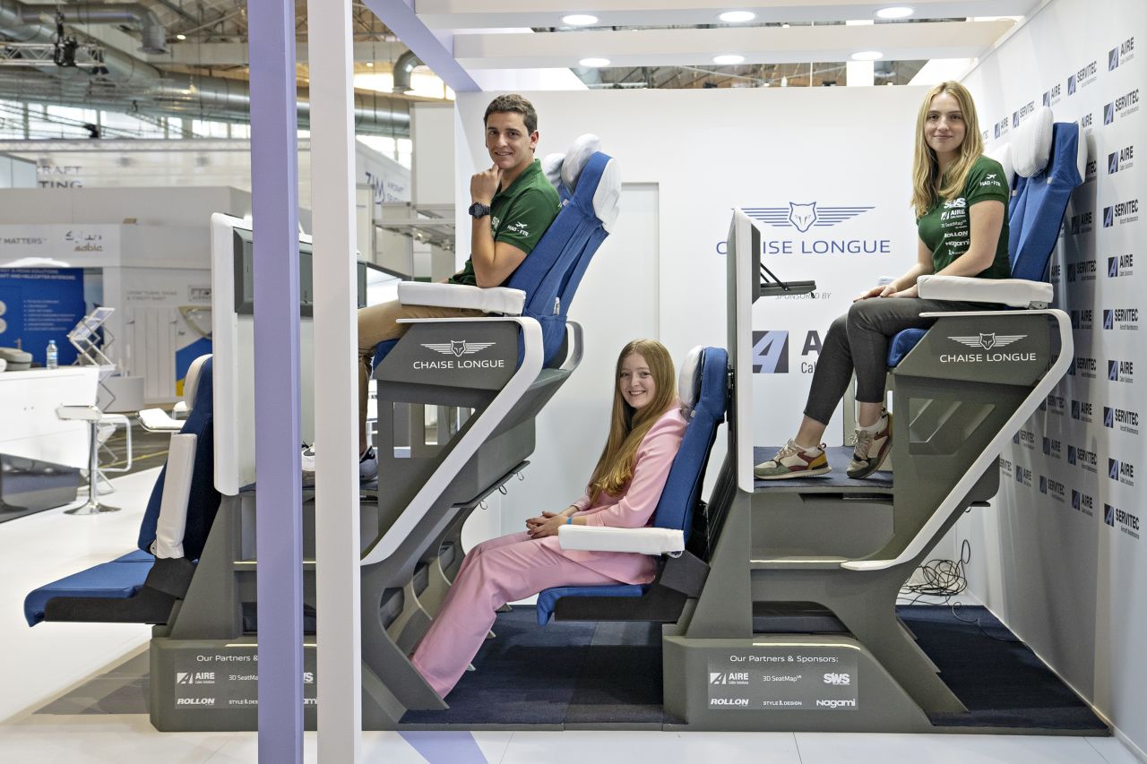 Alejandro Núñez Vicente, left, designed the Chaise Longue double level airplane seat concept.  CNN Travel's Francesca Street, center, tested out the latest iteration of the design.