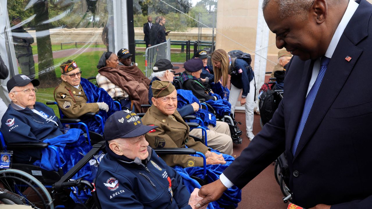 US Secretary of Defense Lloyd Austin shakes hands with World War II veterans during a remembrance ceremony on June 6. 