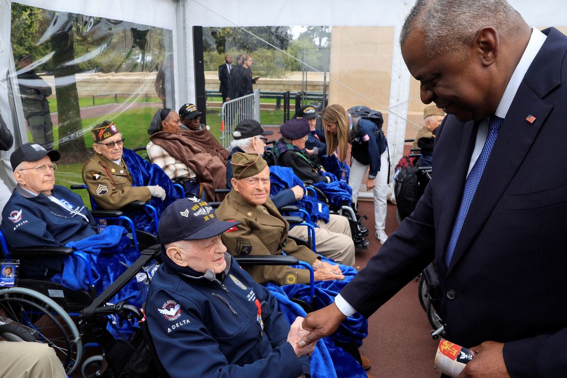 US Secretary of Defense Lloyd Austin shakes hands with World War II veterans during a remembrance ceremony on June 6. 