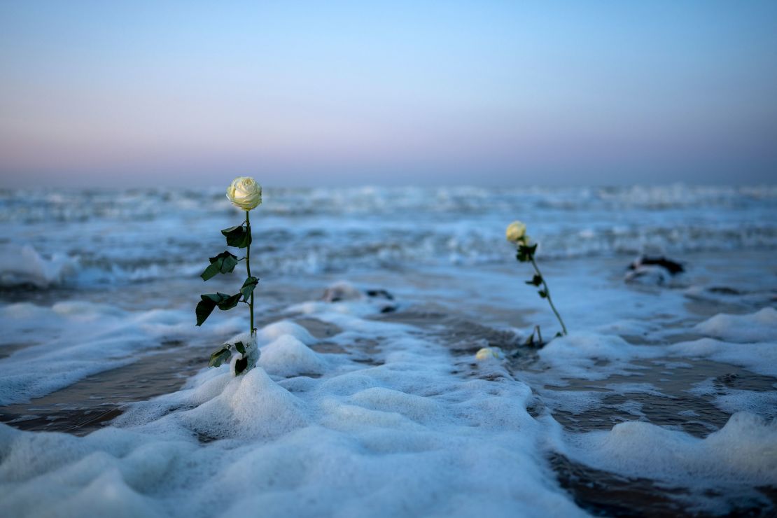 Roses placed on Omaha Beach ahead of D-Day commemorations are claimed by the incoming tide on June 4, in Colleville-sur-Mer, France.