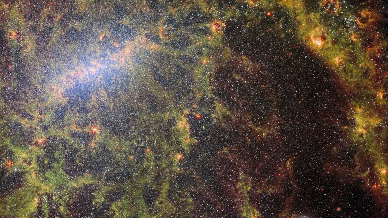 This is a composite image of two snapshots the James Webb Space Telescope took of the galaxy NGC 5068: one captured by the telescope’s Near-Infrared Camera, or NIRCam, and the other by the Mid-Infrared Instrument, or MIRI.
