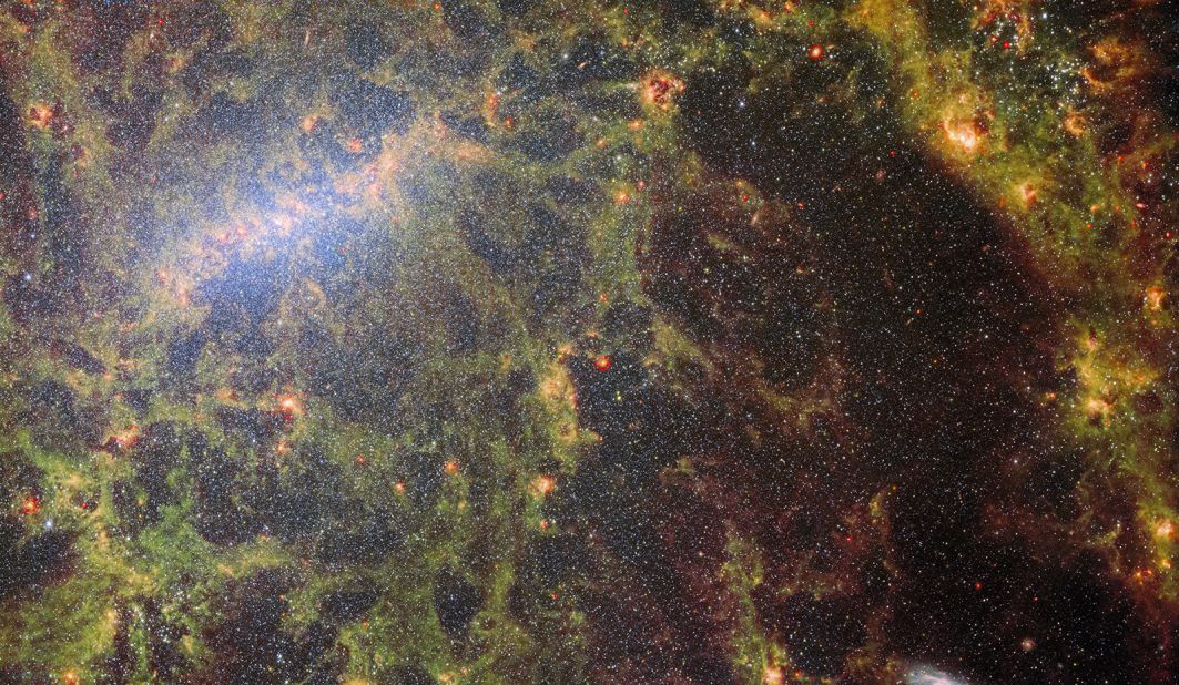 This composite image, shot from the James Webb Space Telescope's MIRI and NIRCam instruments, shows the bright clusters of stars and dust from barred spiral galaxy NGC 5068.