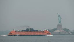 NEW YORK, NEW YORK - JUNE 06: The Staten Island Ferry moves past the Statue of Liberty on a hazy morning resulting from Canadian wildfires on June 06, 2023 in New York City. Over 100 wildfires are burning in the Canadian province of Nova Scotia and Quebec causing air quality health alerts in New York State and parts of New England. (Photo by Spencer Platt/Getty Images)