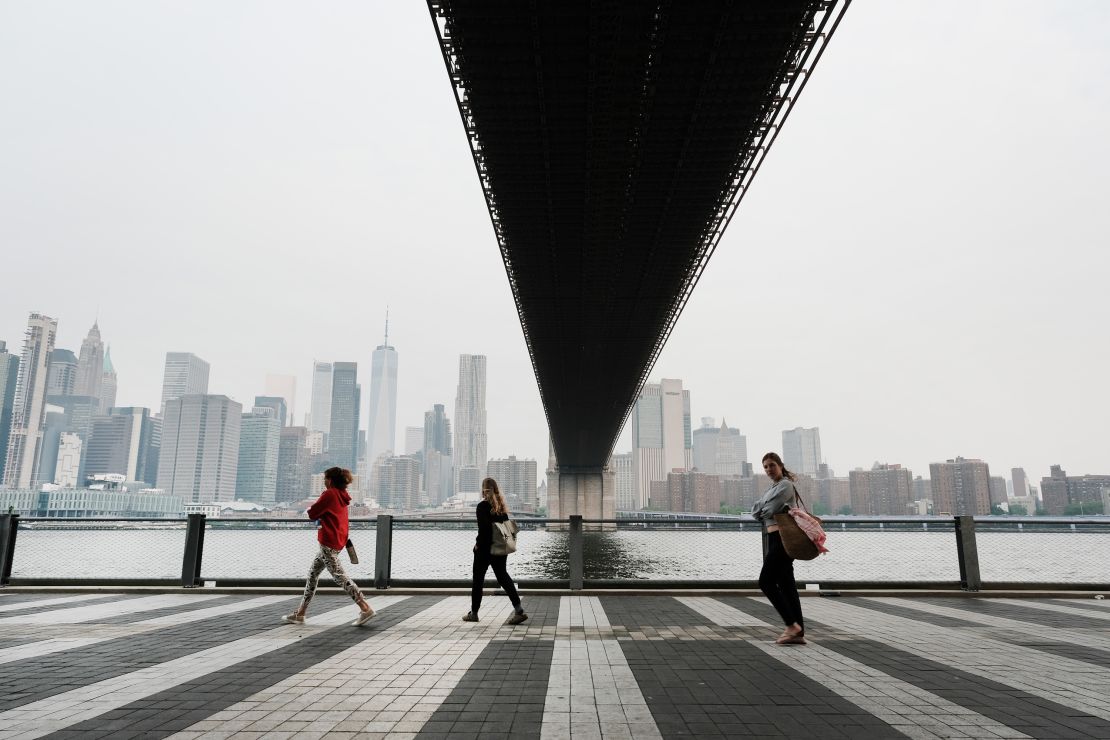 People walk through a Brooklyn Park in New York City on Tuesday morning. Air pollution levels were unhealthy for sensitive groups due to smoke from Canada's wildfires.