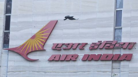FILE PHOTO: A bird flies over a logo of Air India airlines at the corporate headquarters in Mumbai, India, October 19, 2021. REUTERS/Francis Mascarenhas/File Photo