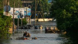 Ukrainian soldiers and first responders search for survivors on the streets of Kherson in a boat, after the destruction of the nearby Nova Kakhovka dam flooded large parts of the city.