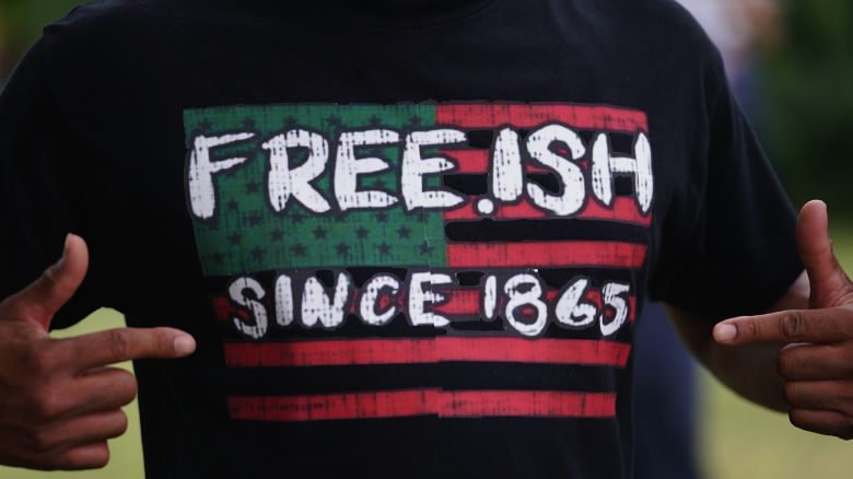 A man displays a shirt celebrating the freedom of enslaved Black people during the Juneteenth celebration in the Greenwood District on June 19, 2020 in Tulsa, Oklahoma. 