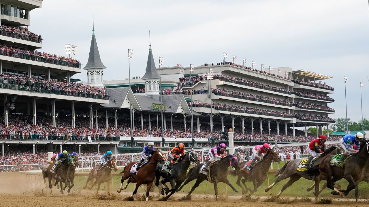 FILE - Javier Castellano, atop Mage, third from left, is seen behind with others behind the pack as they make the first turn while competing in the 149th running of the Kentucky Derby horse race at Churchill Downs Saturday, May 6, 2023, in Louisville, Ky. Churchill Downs will limit horses to four starts during a rolling eight-week period and impose ineligibility standards for continued poor performance in the wake of the recent deaths of 12 horses at the home of the Kentucky Derby. (AP Photo/Julio Cortez, File)