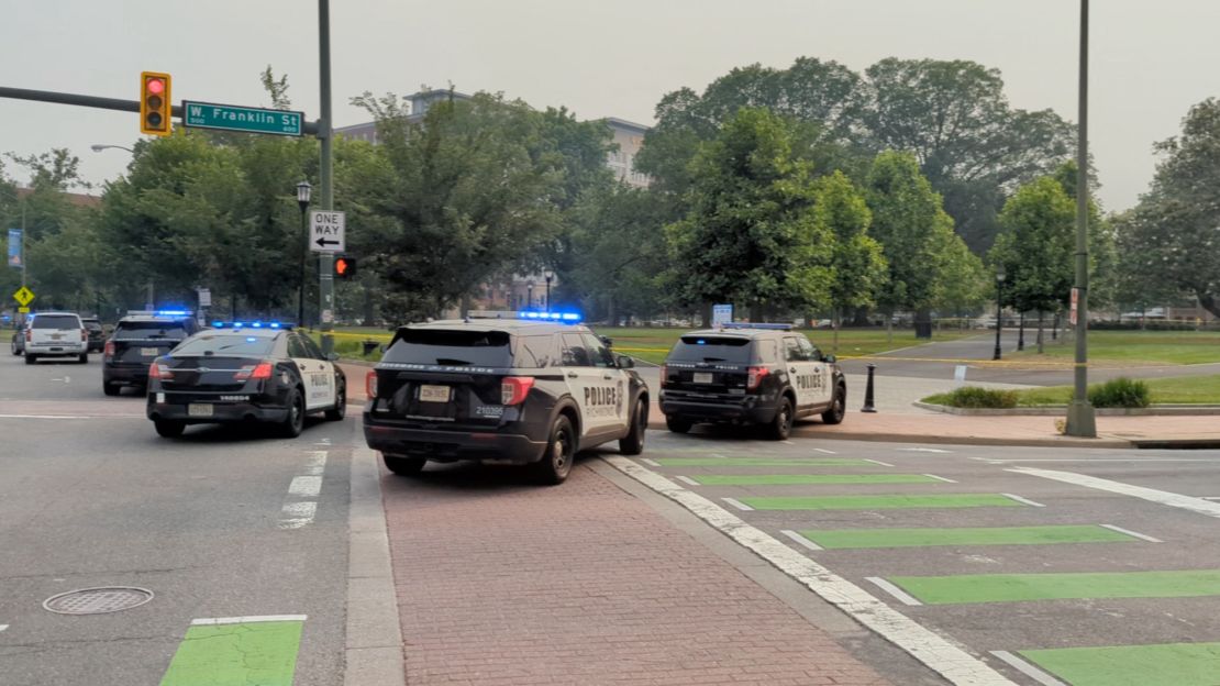 Police vehicles are seen at a park where a gunman opened fire in Richmond, Virginia, on Tuesday.