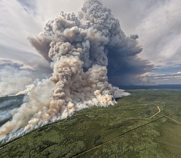 Smoke billows upwards from a planned ignition by firefighters who were tackling the Donnie Creek Complex wildfire south of Fort Nelson, British Columbia, on June 3.