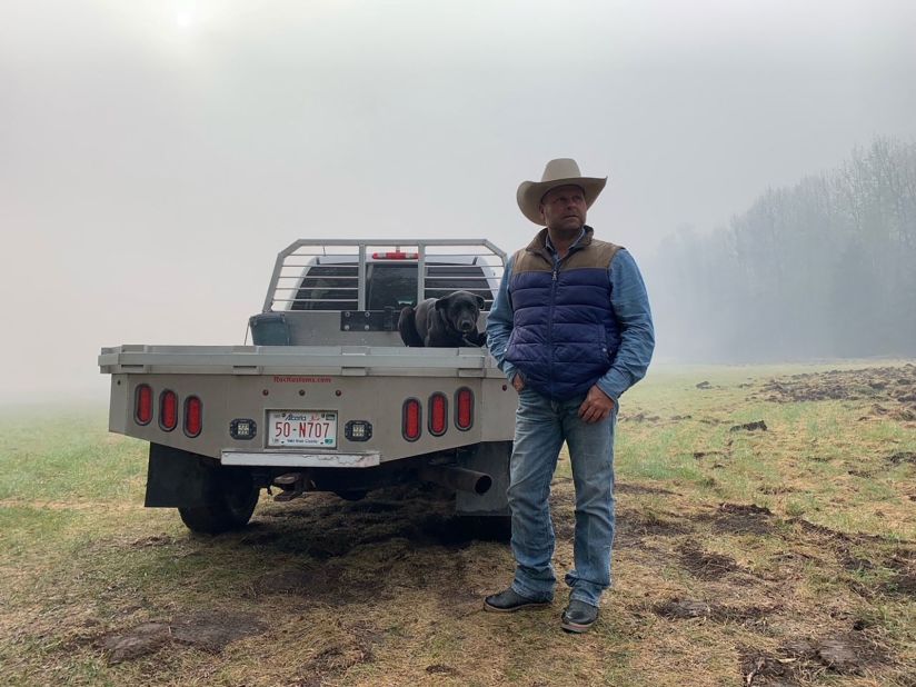 BJ Fuchs, a farmer who has lost some land and had to move his cattle due to the wildfires, stands in Shining Bank, Alberta, on May 11.