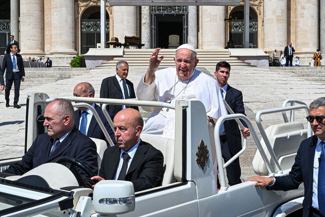 Pope Francis waves as he leaves an event in the popemobile on June 7.