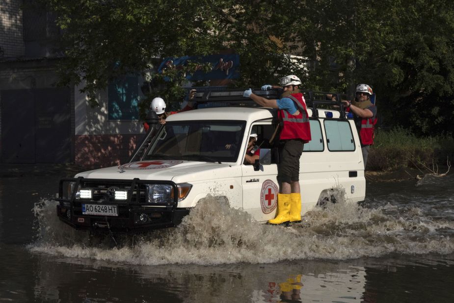 Red Cross workers drive along a street in Kherson on June 6.