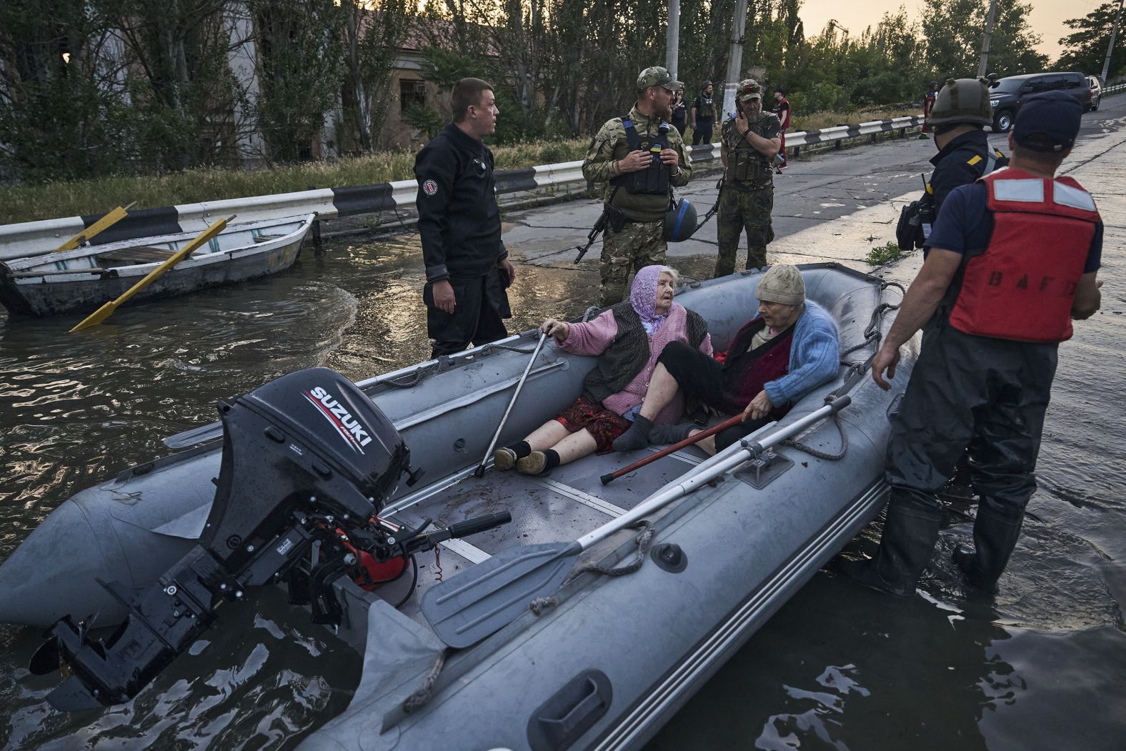 Rescue workers attempt to tow boats carrying evacuated residents on June 6.