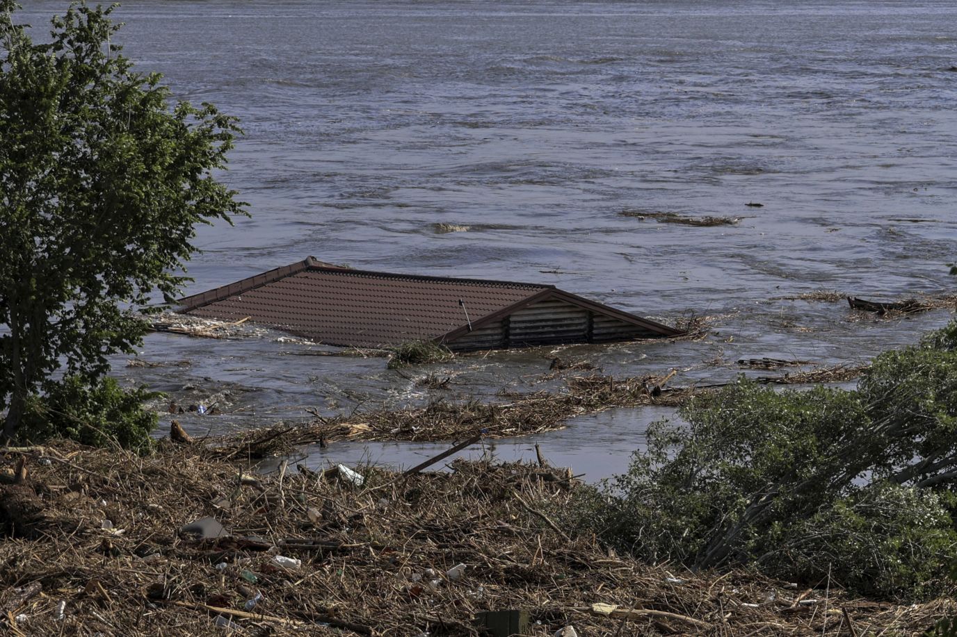 The roof of a house is seen in the flooded Dnipro River in Kherson.