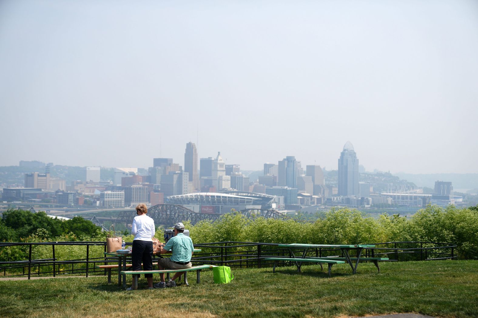 A couple sits for lunch in Cincinnati on June 6. Smoke from the Canadian wildfires had drifted to the city, causing the air to appear hazy.