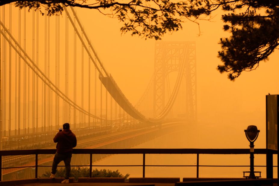 A person in Fort Lee, New Jersey, talks on the phone near the George Washington Bridge on June 7.