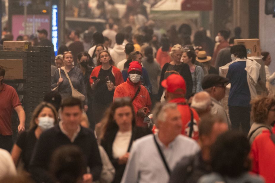 People wear face masks as they walk in New York's Herald Square on June 7.