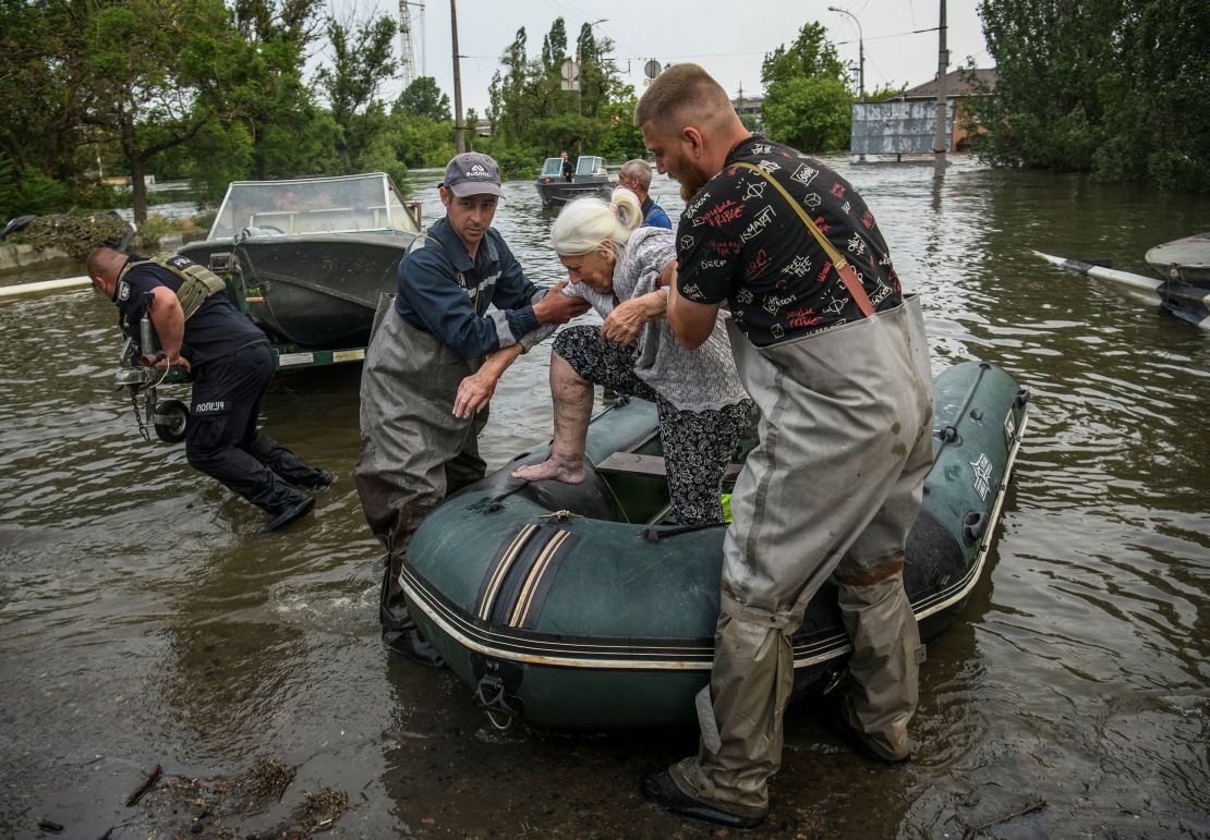 Rescuers evacuate a local resident from a flooded area after the Nova Kakhovka dam breached in Kherson, Ukraine, on June 7.