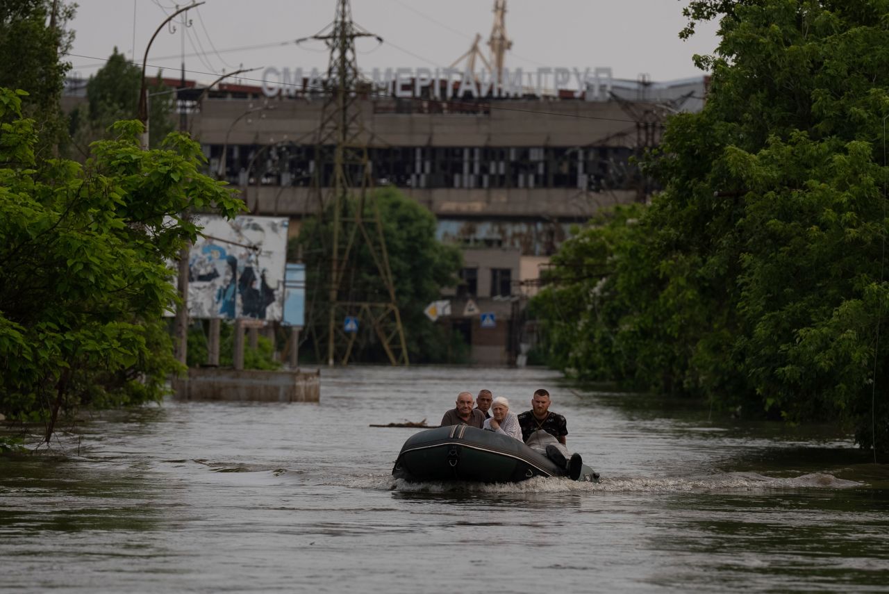 Rescue workers evacuate an elderly woman and her husband from a flooded neighborhood in Kherson, Ukraine, on Wednesday, June 7.