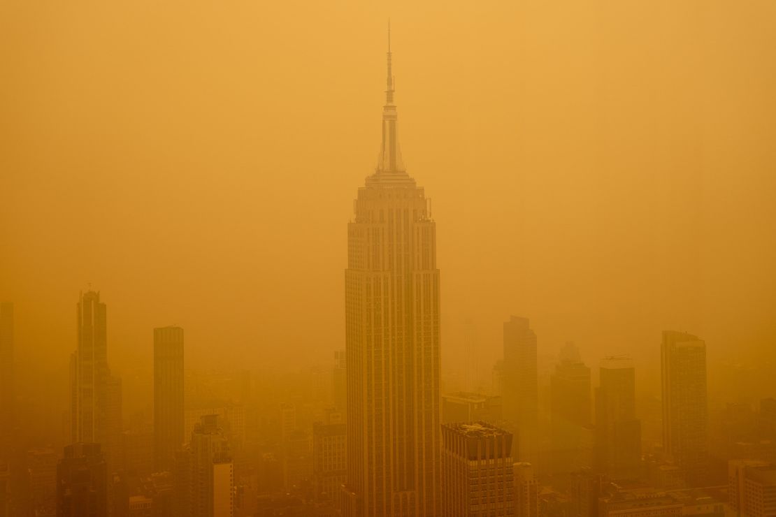 A thick, orange haze from wildfires in Canada diminishes the visibility of the Empire State Building on June 7 in New York City.
