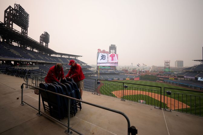 Workers chain up seats at Citizens Bank Park after the Philadelphia Phillies postponed a baseball game because of poor air quality on June 7. The New York Yankees also postponed a game that night.