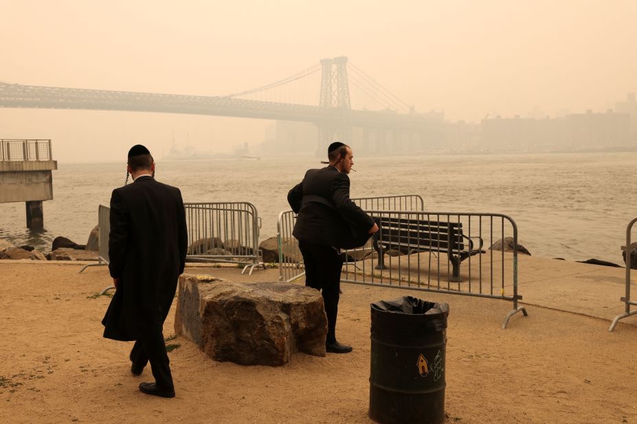 Two men stand by the waterfront in Brooklyn, New York, on June 7.