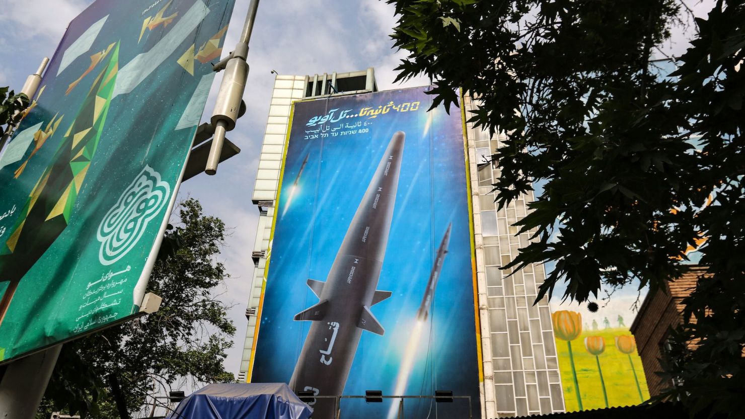 A giant billboard bearing a picture of the 'Fattah' hypersonic missile covers the side of a building in Tehran on Wednesday.