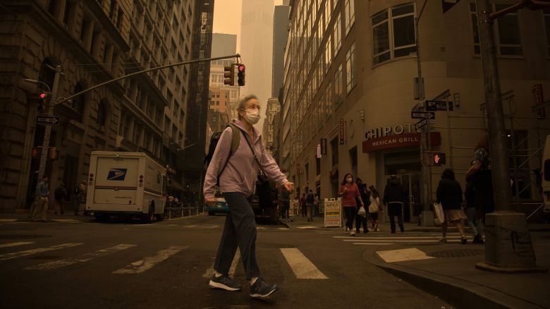 A pedestrian wearing a face mask walks on a street in New York, the United States, June 7, 2023. Smoke from raging wildfires in Canada has triggered air quality alerts in a number of U.S. states, with the sky over New York City quickly darkening Wednesday afternoon and New York State Governor Kathy Hochul calling the worsening air quality "an emergency crisis."